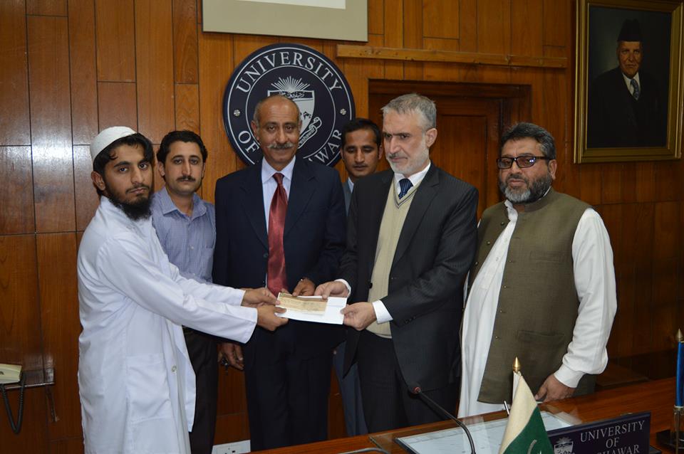 Mr. Haseeb Ahmad s/o Haya Khan BISE Peshawar Roll No. 77401 receiving Rs: 50000/- Cheque from the honourable Vice Chancellor, University of Peshawar