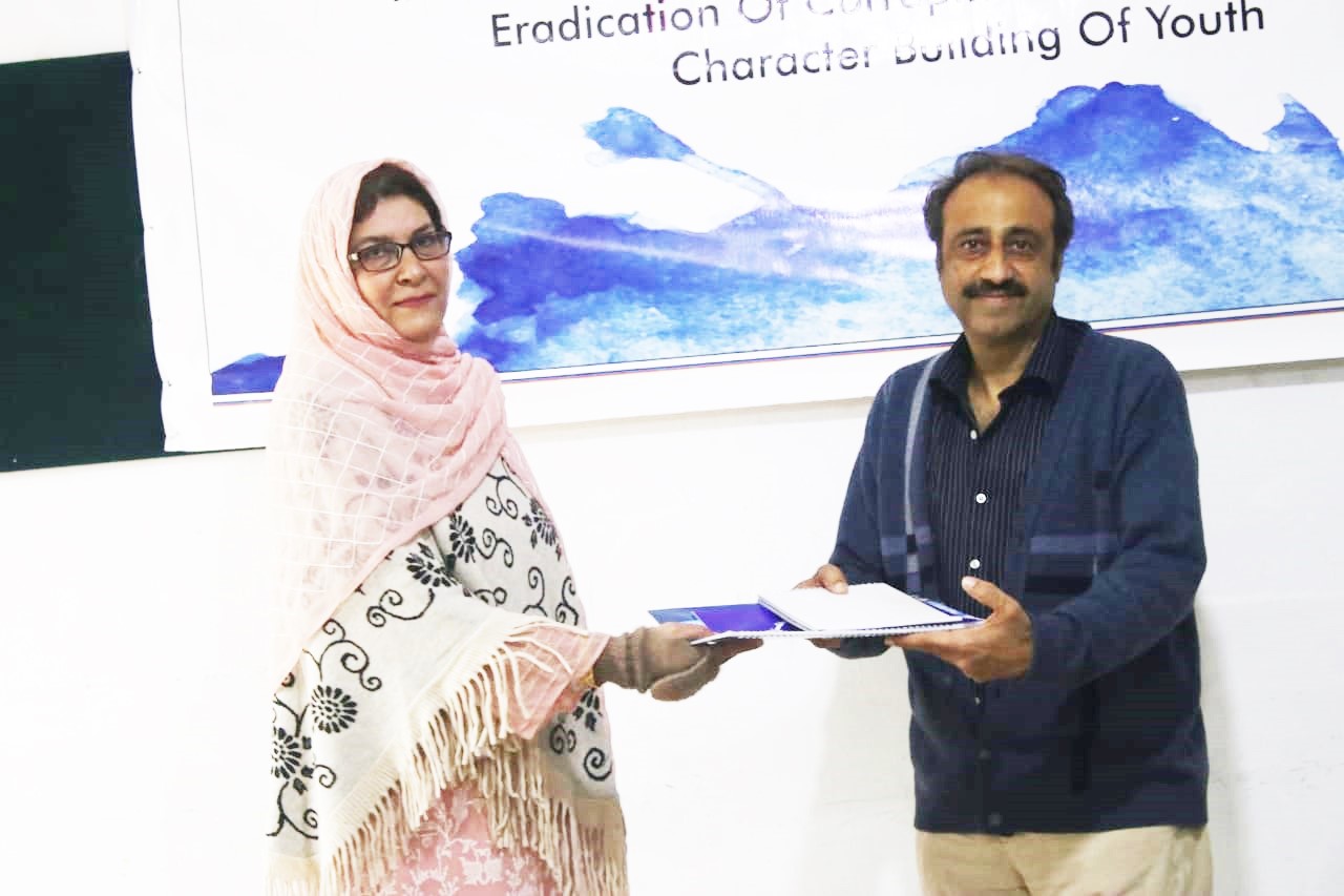 HoD Mrs Farida Rasheed giving away the certificate and calendar copy to Mr Younas Masood Communication Design year III Class Teacher
