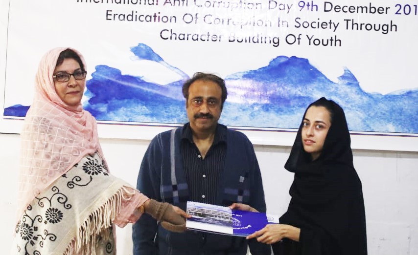 HoD Mrs Farida Rasheed giving away the certificate and calendar copy to Miss Sheza Zaman (design selected and printed)  year III communication design supervised by Mr Younas Masood