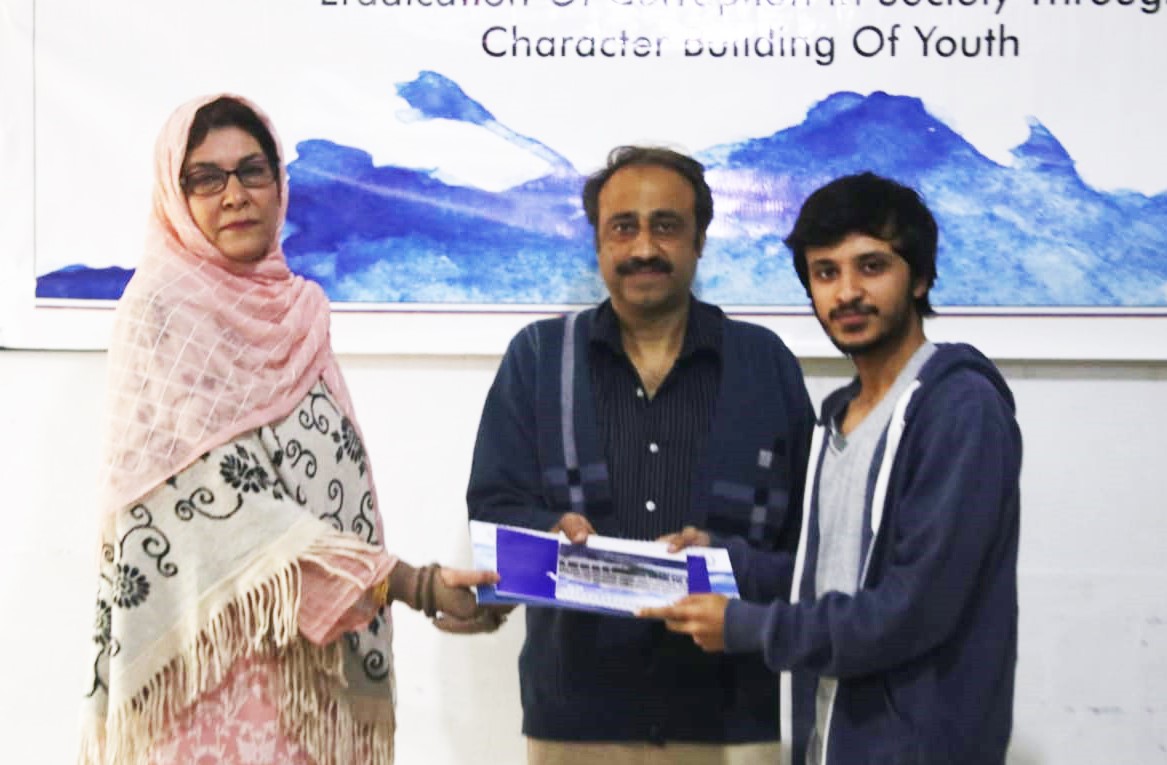 HoD Mrs Farida Rasheed giving away the certificate and calendar copy to Mr Mohsin Javed ( Design Selected and Printed) year III communication design supervised by Mr Younas Masood