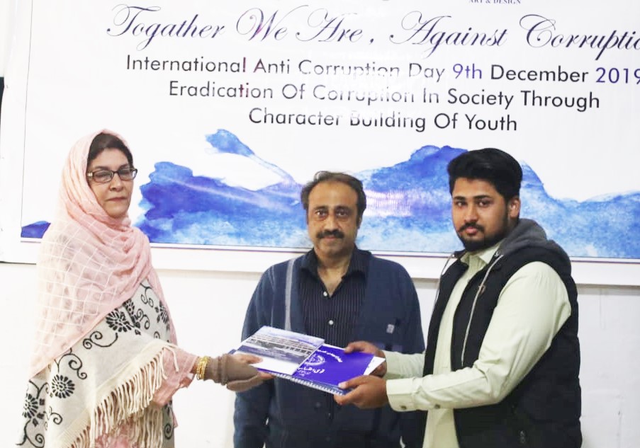 HoD Mrs Farida Rasheed giving away the certificate and calendar copy to Mr Noor ul Hasan  year III communication design supervised by Mr Younas Masood