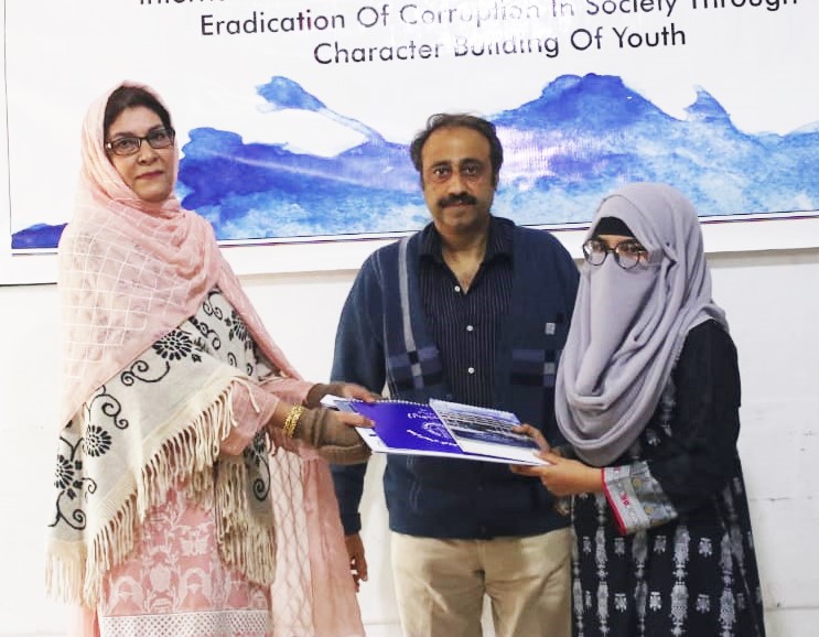 HoD Mrs Farida Rasheed giving away the certificate and calendar copy to Miss Shumaila Irshad year III communication design supervised by Mr Younas Masood