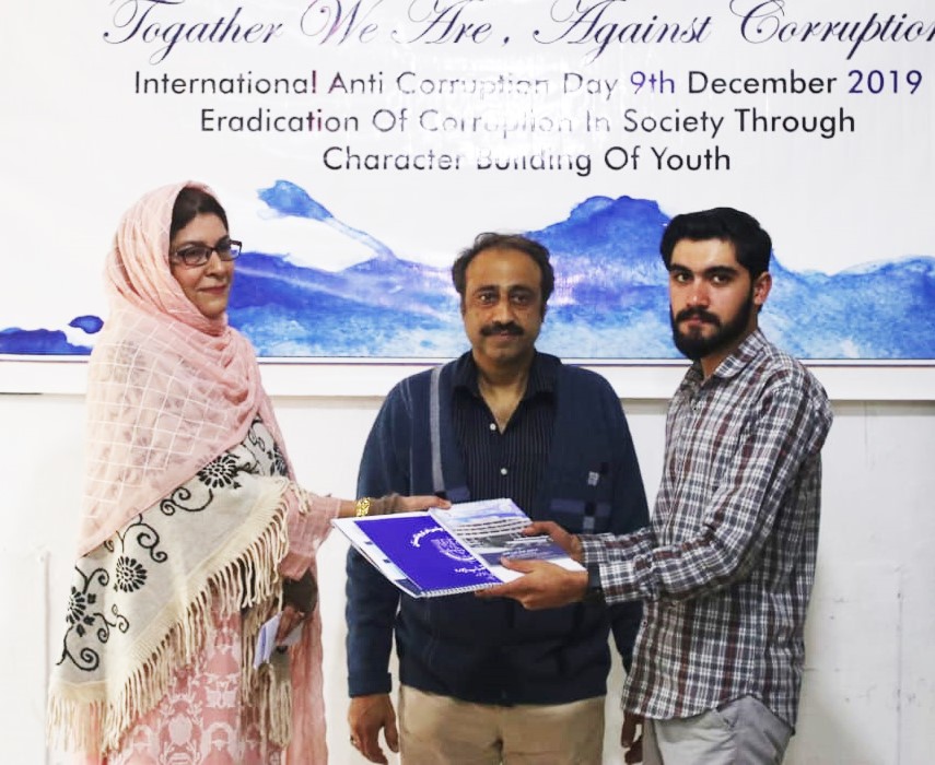 HoD Mrs Farida Rasheed giving away the certificate and calendar copy to Mr Gohar Ayub year III communication design supervised by Mr Younas Masood
