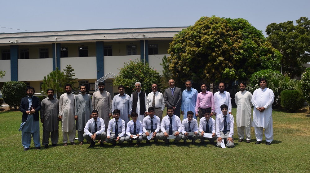 The Vice Chancellor University of Peshawar Prof. Dr. Muhammad Asif Khan is posing with the outstanding students of University College for Boys and faculty members on 15th July,2019.