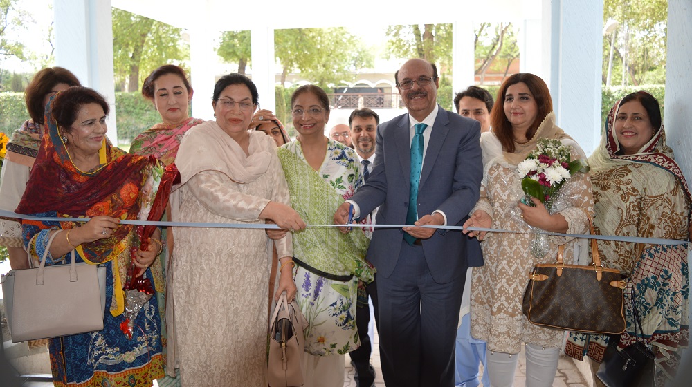 The Vice Chancellor University of Peshawar is cutting the blue ribbon to inaugurate the floral exhibition  organised under the auspices  of Peshawar University Teachers Association female executive members on 30th April, 2019.
