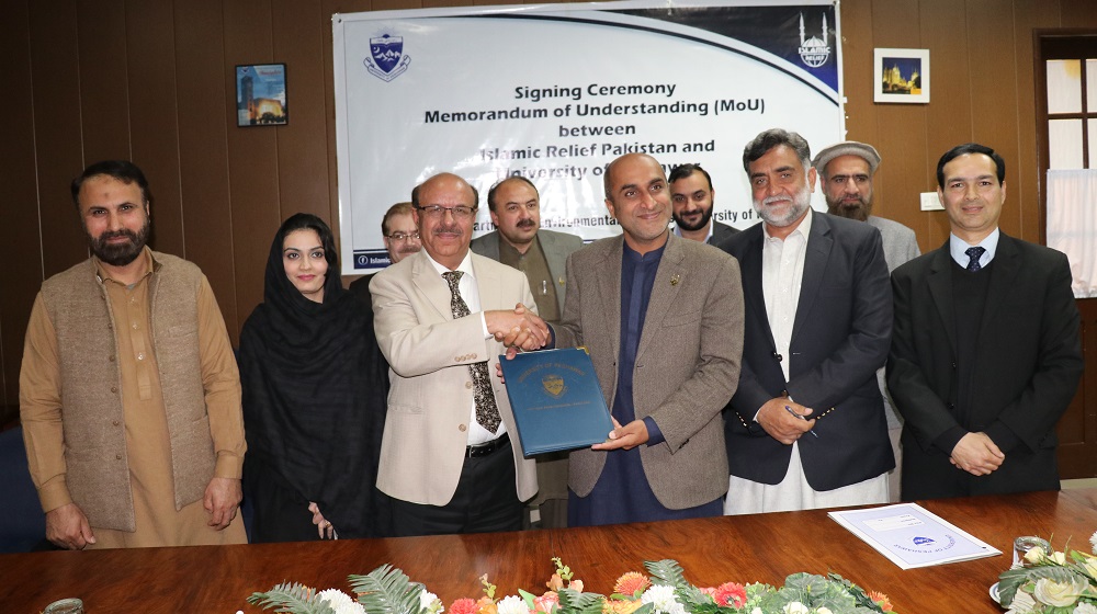 Vice Chancellor University of Peshawar is shaking hands  and sharing MoU copies with acting country director, Islamic Relief Pakistan  Raza Narejo for promoting  mutual environmental projects at Committee room I   University of Peshawar on 30th January, 2020.