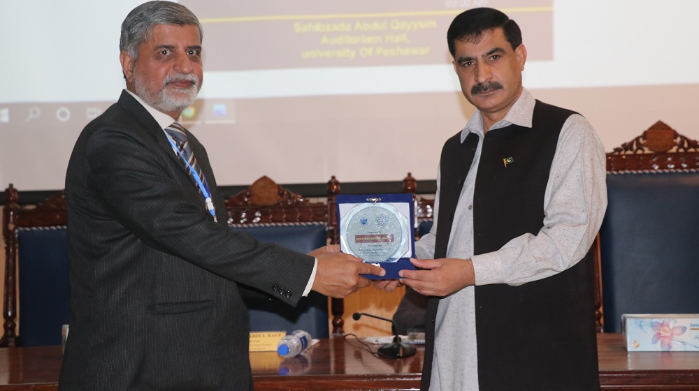 Chairman department of Political Science Dr Abdul Rauf presents a souvenir to the vice Chancellor Prof Dr Muhammad Idrees on the 10th International conference themed 