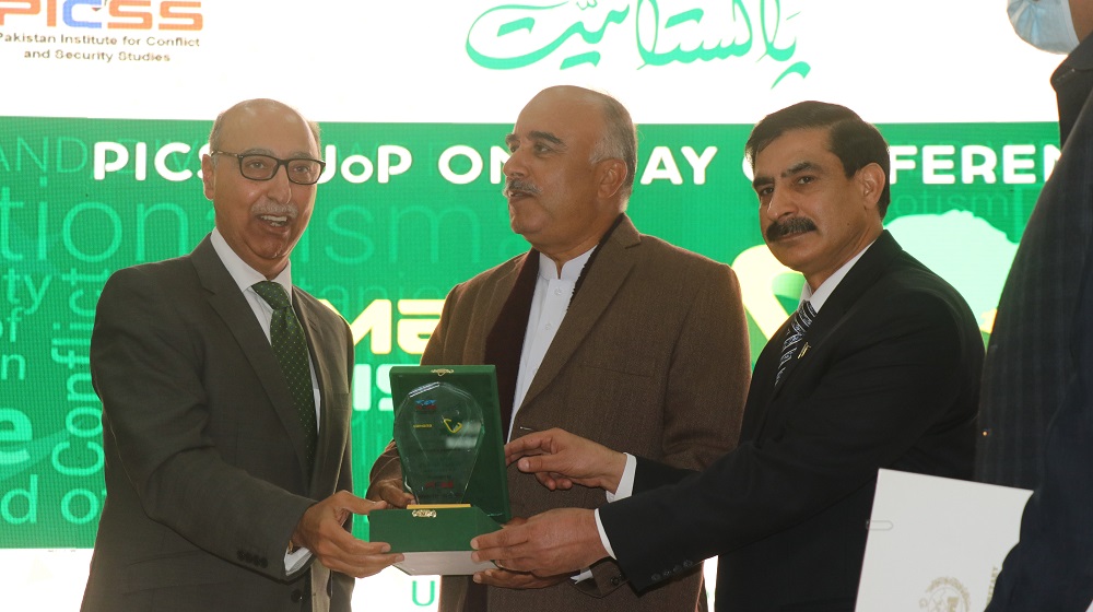 Vice Chancellor Prof Dr Muhammad Idrees and President Pakistan Institute for Conflict & Security Studies Abdul Basit present a souvenir to the Chancellor University of Peshawar, Governor KP Shah Farman in a jointly organized seminar at University of Peshawar.