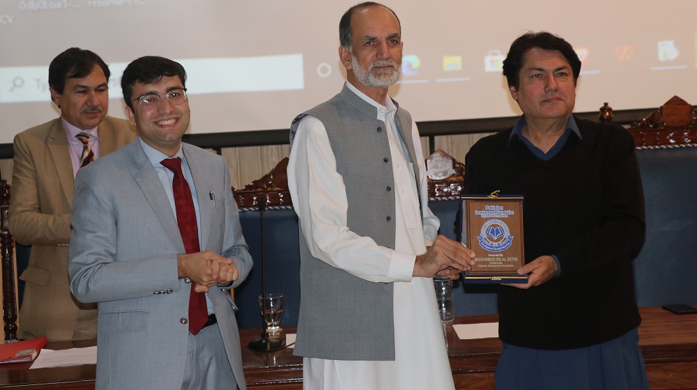 Dean Faculty of Social Sciences Prof Dr Zahid Anwar presents a souvenir to the Barrister Dr Muhammad Ali Saif in a program themed 