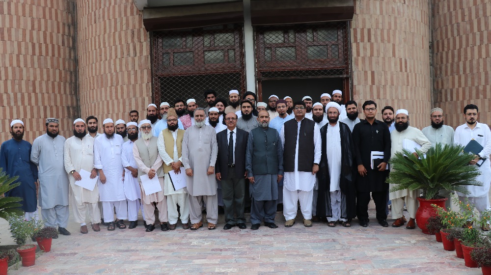 Participants of Paigham-e-Pakistan moot, jointly organized by the Islamic Research Institute(IRI) of International Islamic University Islamabad and University of Peshawar pose for a group photo with the Vice Chancellor University of Peshawar Prof. Dr. Muhammad Asif Khan.