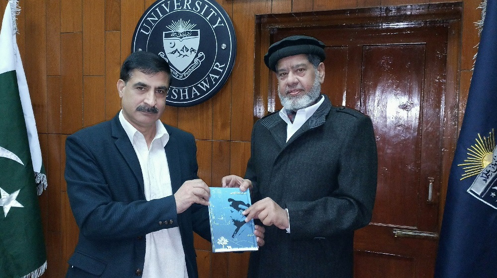 Ex-Treasurer University of Peshawar Iftikhar Hussain Khan presents his book to the Vice Chancellor UoP Prof Dr Muhammad Idrees.